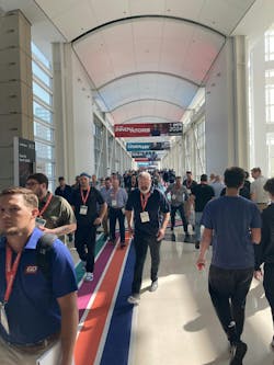 IMTS attendees cross the sky bridge from the North and South halls, heading to the East wing of the show . IMTS attendees cross the sky bridge from the North and South halls, heading to the East wing of the show .