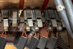 Figure 3. Brushes being lifted in preparation for storage of a DC machine. Figure 3. Brushes being lifted in preparation for storage of a DC machine.