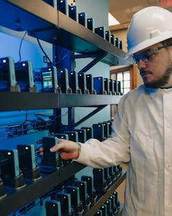 Figure 1: Before starting a shift, workers grab a radio from the Walt PowerWall. Figure 1: Before starting a shift, workers grab a radio from the Walt PowerWall.