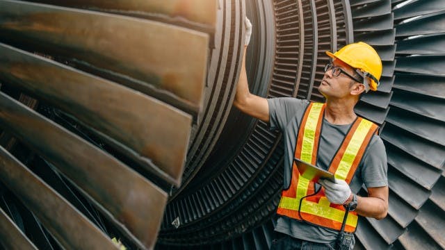 Worker checking turbine health