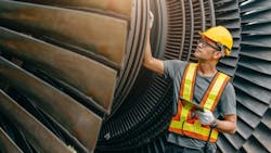 Worker checking turbine health Worker checking turbine health