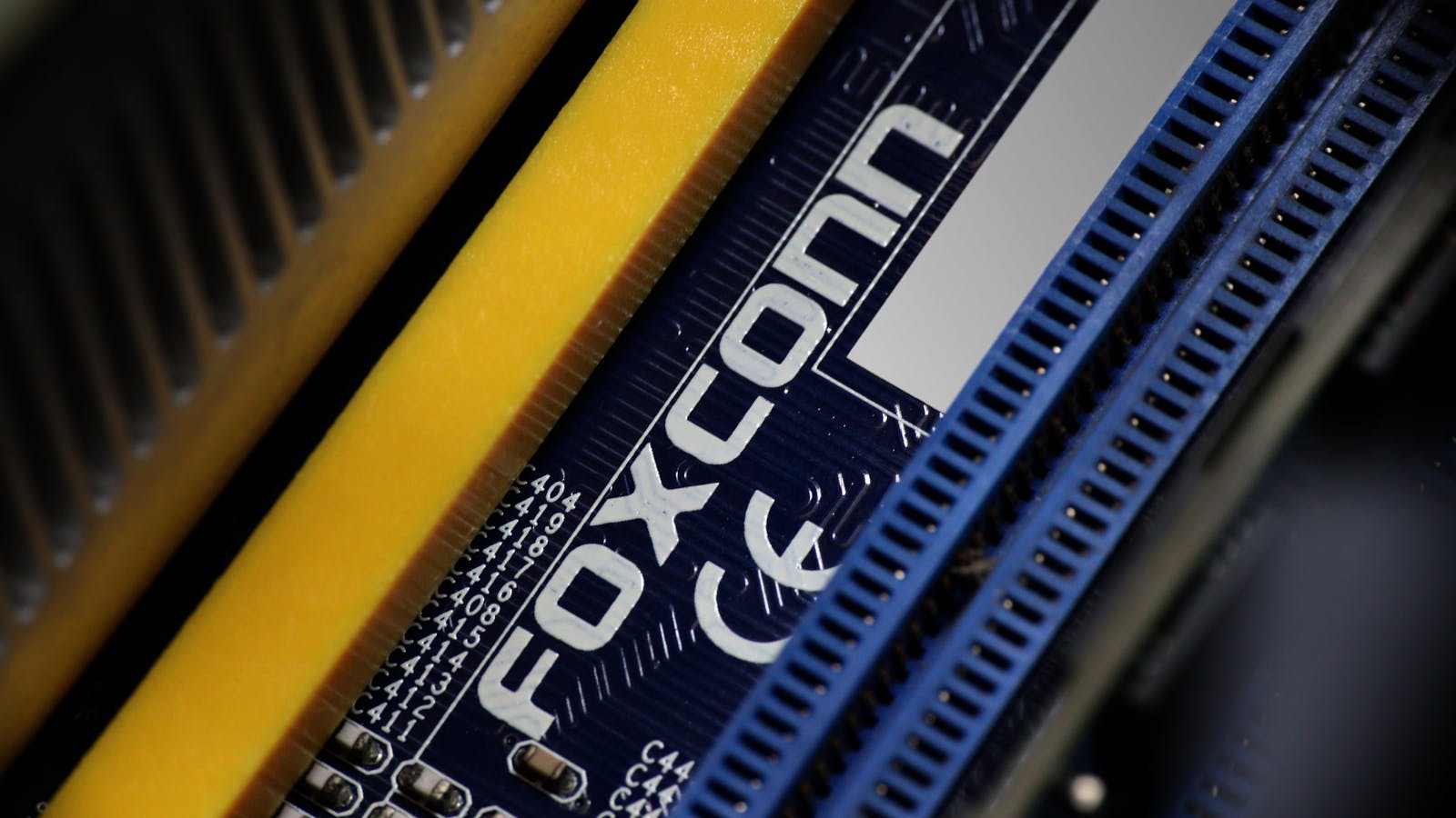Closeup of the Foxconn logo printed on a computer motherboard.