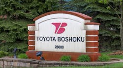 An photograph of a Toyota Boshoku sign outside one of its company locations. An photograph of a Toyota Boshoku sign outside one of its company locations.