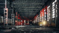 Interior of a large, abandoned warehouse or factory. Interior of a large, abandoned warehouse or factory.