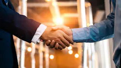 Two men in office clothes shake hands
