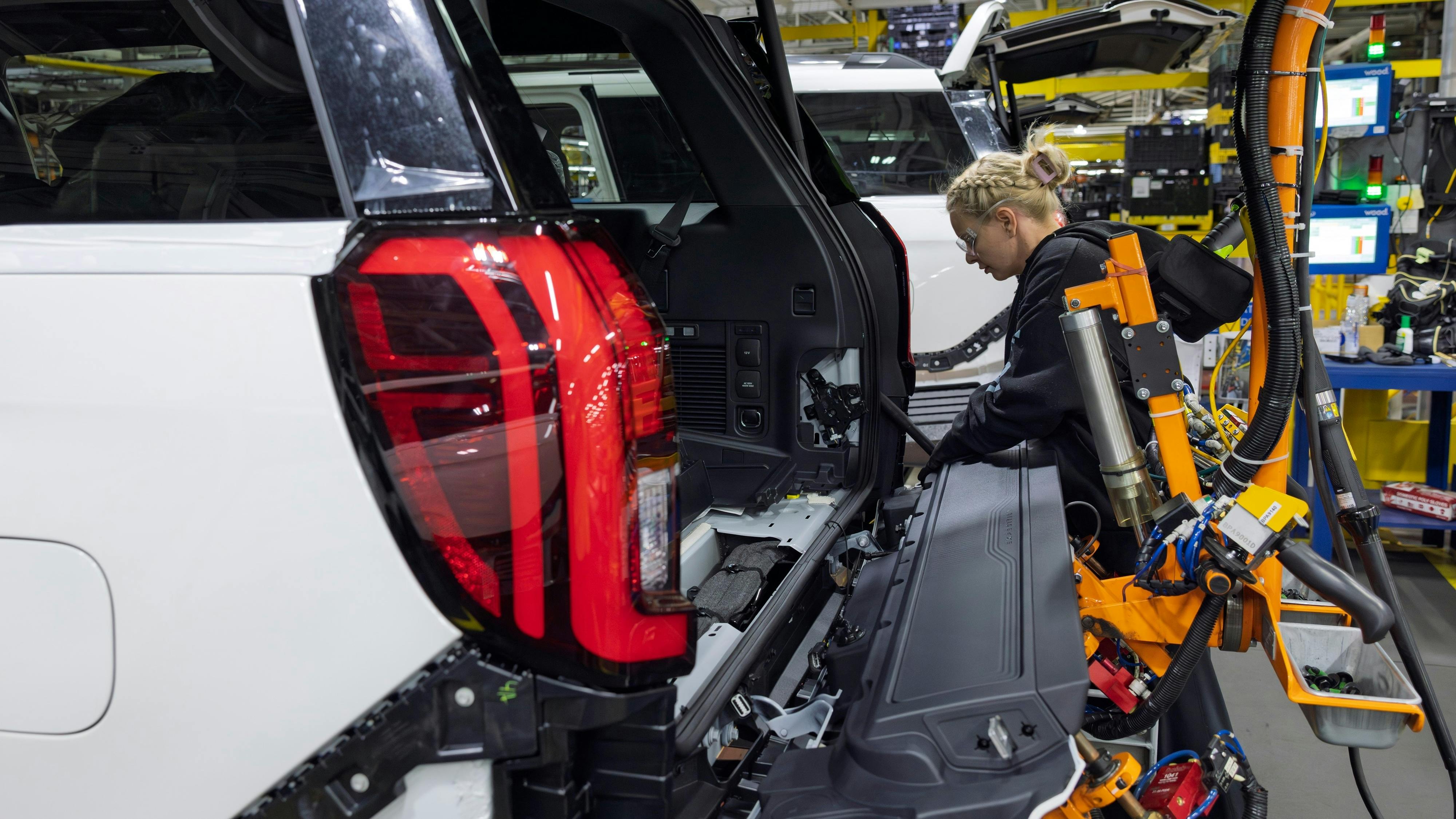 An employee at a Ford plant in Kentucky works on an Expedition SUV. Image credit: Ford