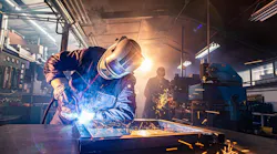 Workers welding and grinding