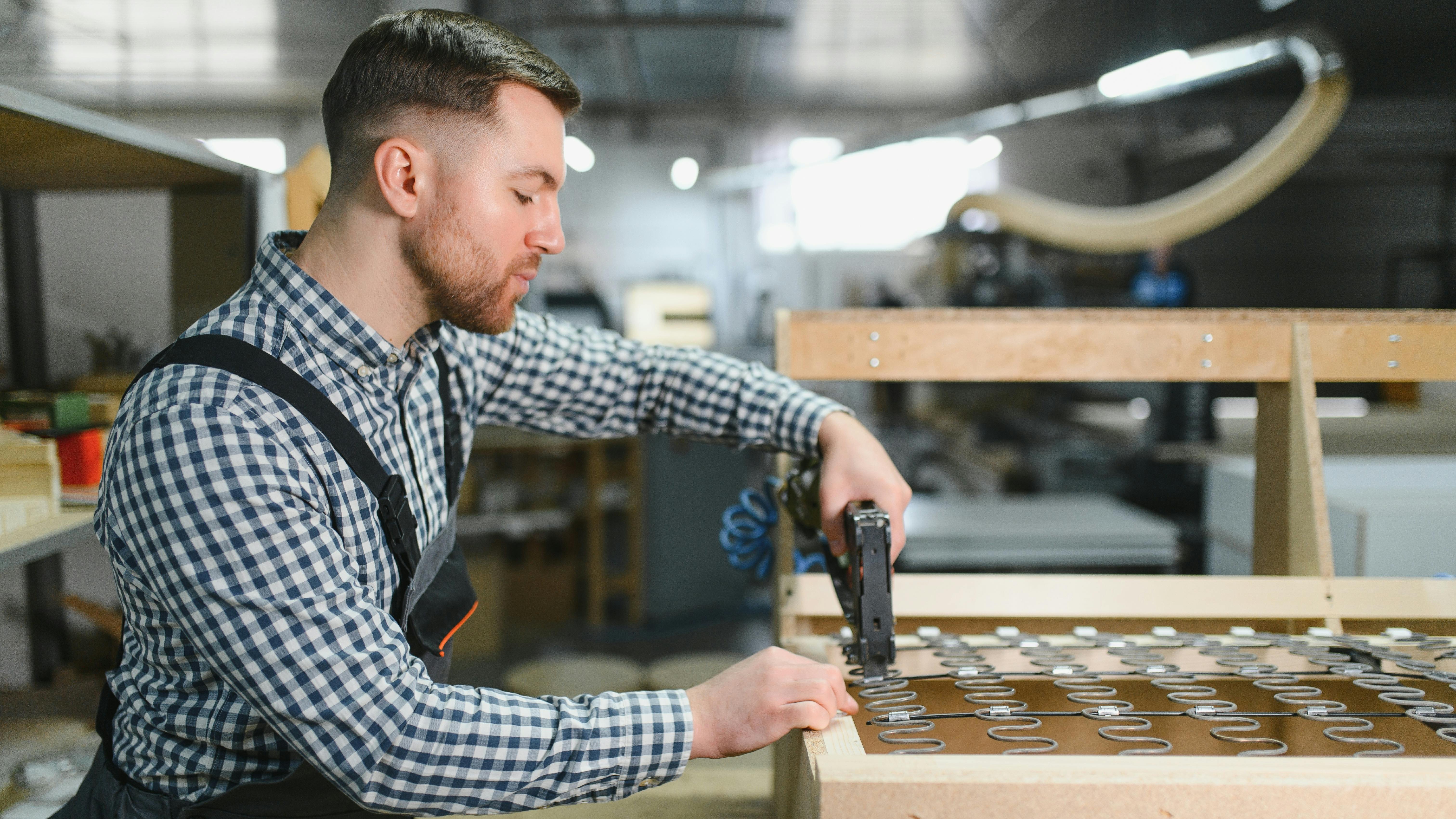 Carpenter assembling a sofa frame