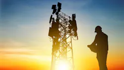 A worker approaches a 5G tower